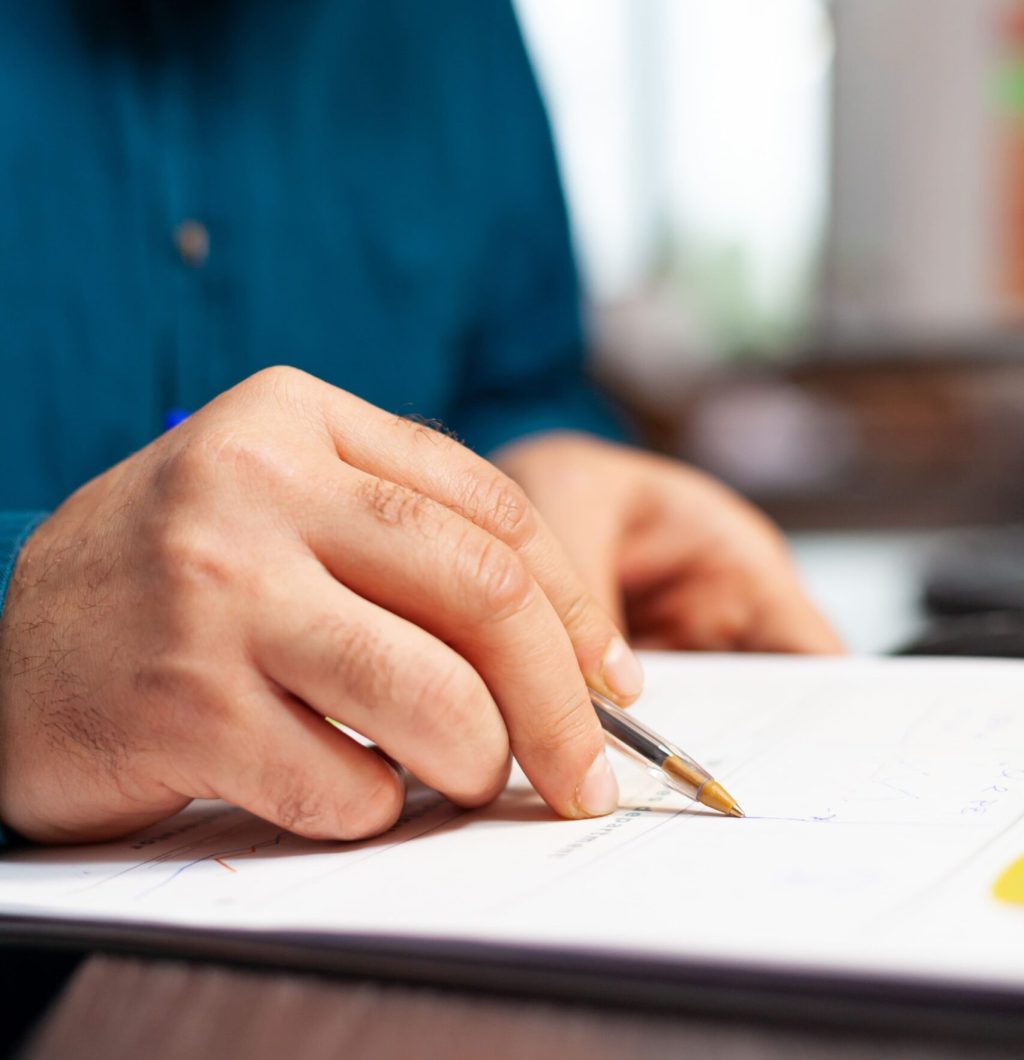 User holding pen and paper