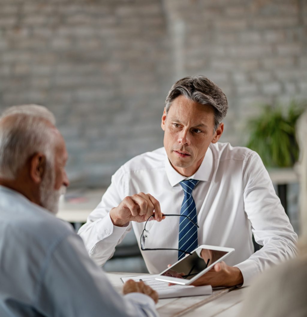 Male professional in office speaking to someone